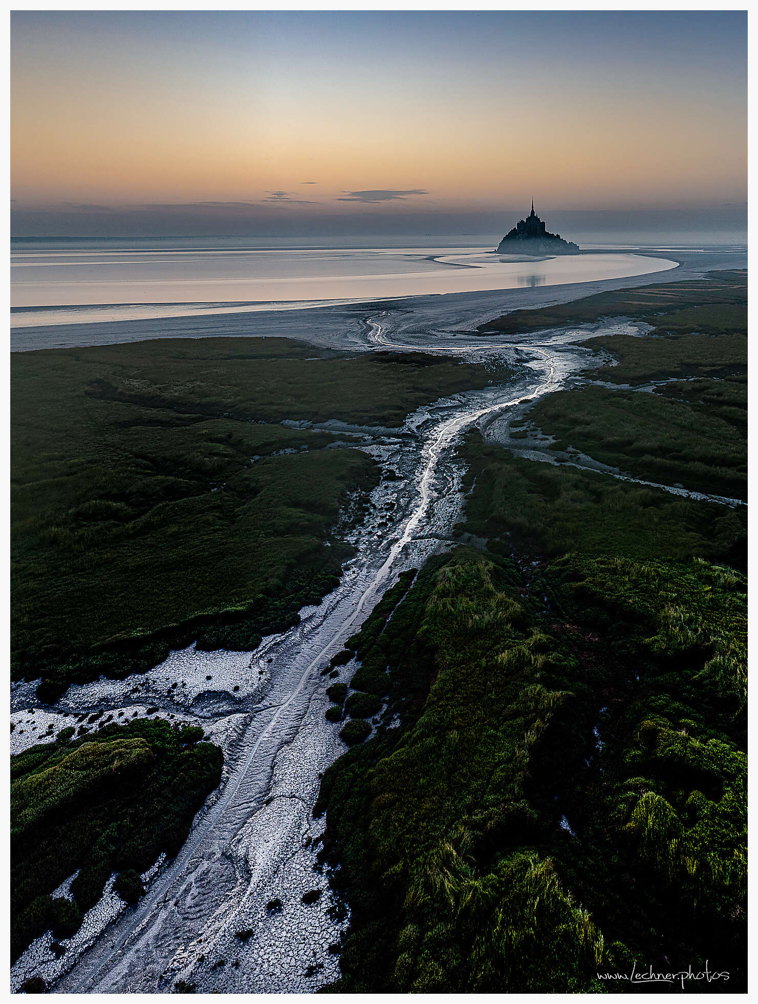 Mont Saint Michel riverbank at sunrise